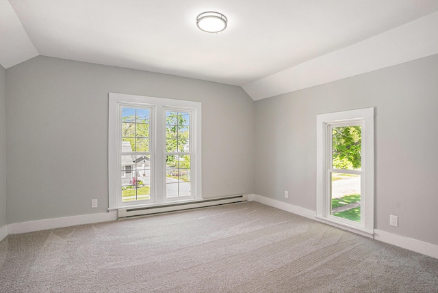 24 W Bernard St, Hartford, MI 49057 - empty room with baseboard heating, vaulted ceiling, plenty of natural light, and light colored carpet