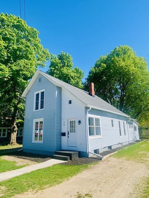 24 W Bernard St, Hartford, MI 49057 - view of property exterior featuring a chimney