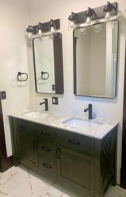 24 W Bernard St, Hartford, MI 49057 - full bathroom featuring marble look tiles and double vanity