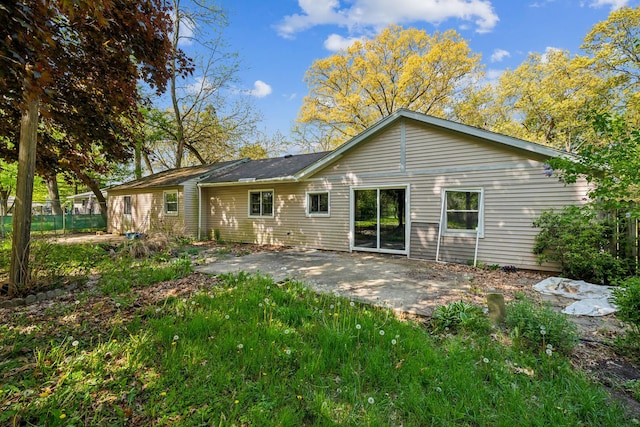 rear view of house featuring a patio and fence