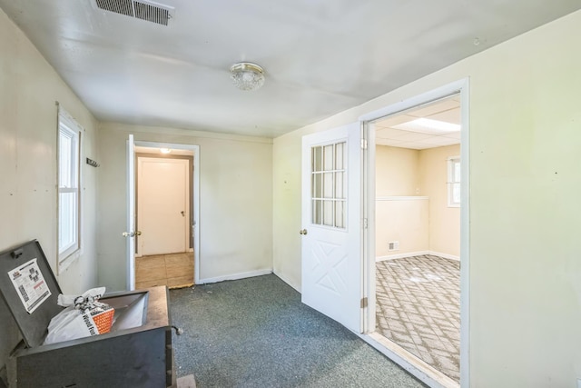 hall featuring carpet and baseboards