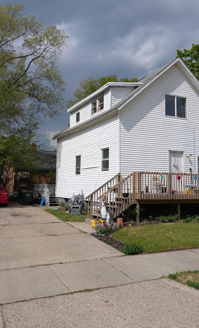 654 E Isabella Ave, Muskegon, MI 49442 - rear view of property featuring a deck