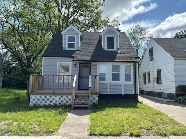 11414 Abington Ave, Detroit, MI 48227 - cape cod house featuring a shingled roof, a wooden deck, and a front lawn
