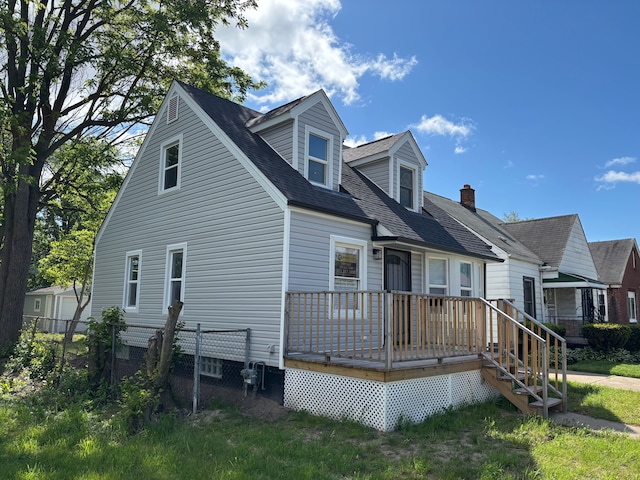 11414 Abington Ave, Detroit, MI 48227 - view of front of home with fence, a wooden deck, and roof with shingles