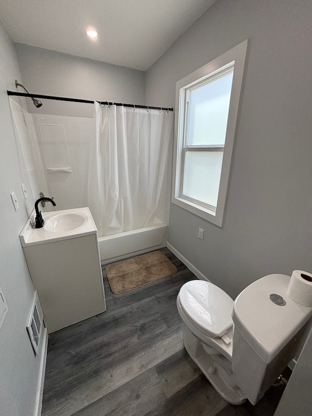 11414 Abington Ave, Detroit, MI 48227 - bathroom featuring toilet, wood finished floors, shower / bath combo with shower curtain, baseboards, and vanity