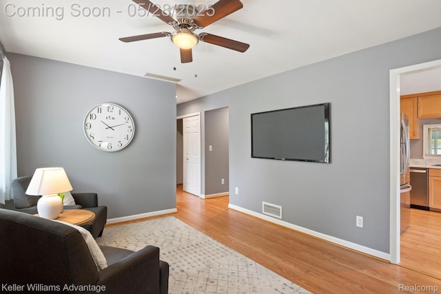 40755 Judd Rd, Belleville, MI 48111 - living room featuring light wood-type flooring, a ceiling fan, and baseboards