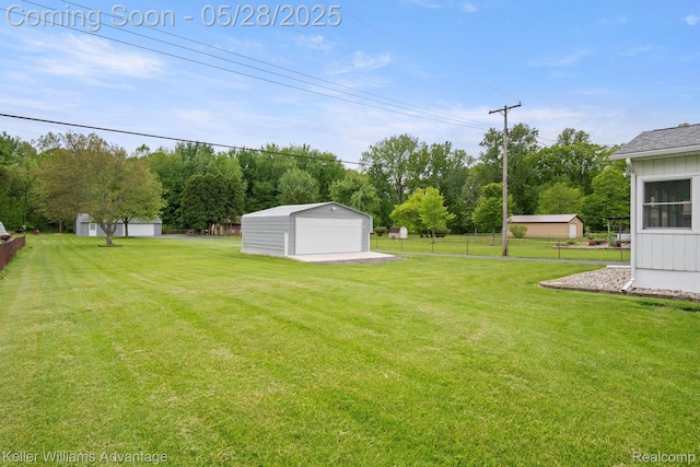 40755 Judd Rd, Belleville, MI 48111 - view of yard featuring a garage, an outdoor structure, and view of wooded area