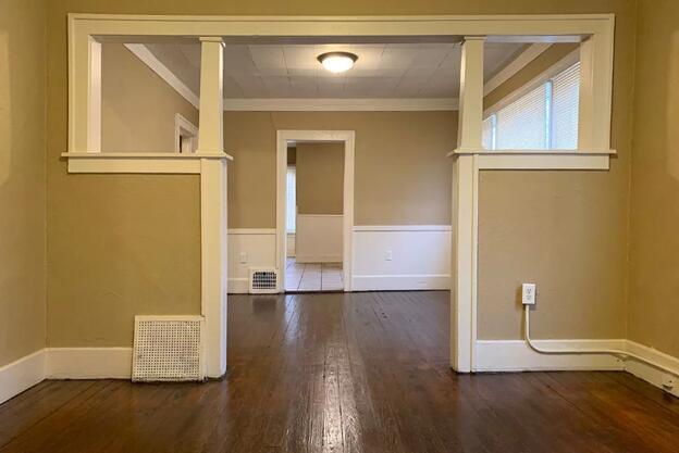 39 Iona Ave, Muskegon, MI 49442 - empty room featuring crown molding, wood finished floors, and baseboards
