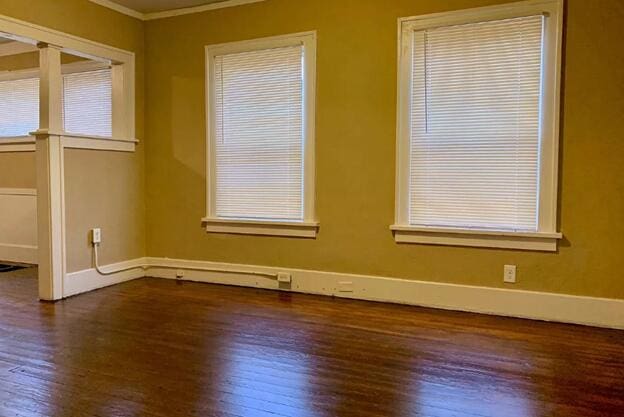39 Iona Ave, Muskegon, MI 49442 - empty room featuring ornamental molding, dark wood-style floors, and baseboards