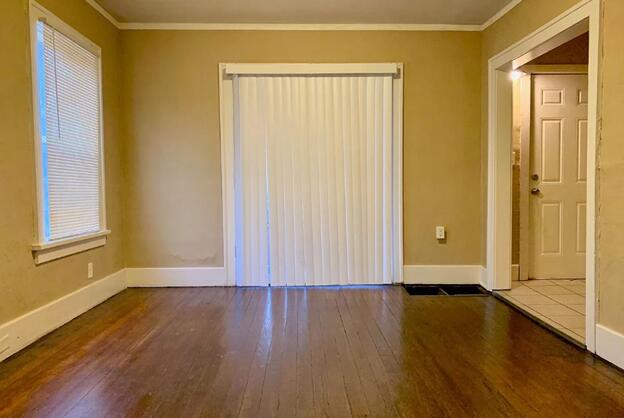 39 Iona Ave, Muskegon, MI 49442 - unfurnished room with hardwood / wood-style floors, baseboards, and ornamental molding
