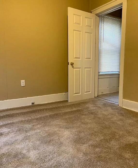 39 Iona Ave, Muskegon, MI 49442 - unfurnished room featuring carpet floors and baseboards