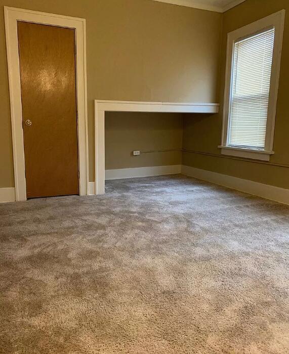 39 Iona Ave, Muskegon, MI 49442 - carpeted empty room featuring baseboards