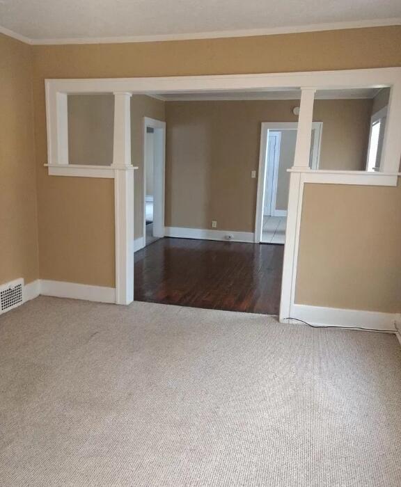 39 Iona Ave, Muskegon, MI 49442 - spare room featuring carpet flooring, baseboards, and ornamental molding