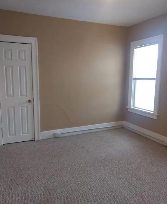 39 Iona Ave, Muskegon, MI 49442 - carpeted empty room featuring baseboards