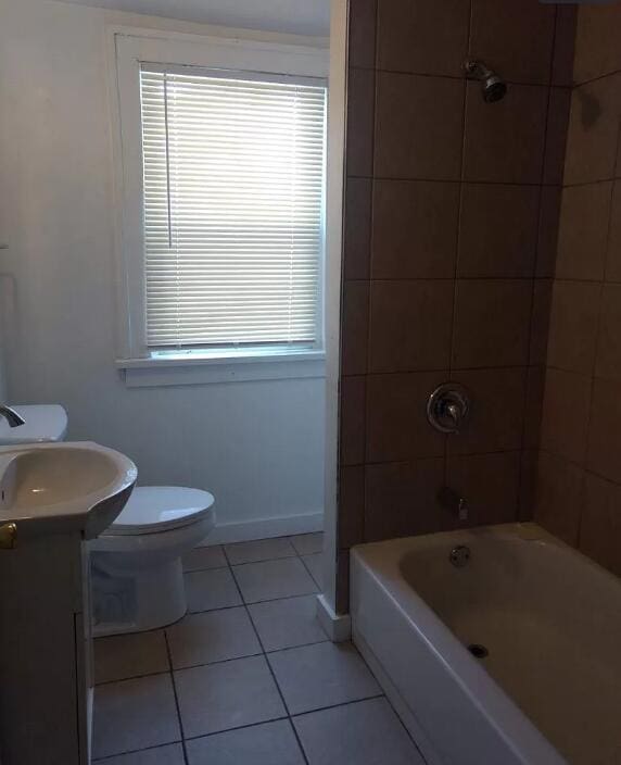 39 Iona Ave, Muskegon, MI 49442 - full bath with tile patterned floors, plenty of natural light, toilet, and vanity