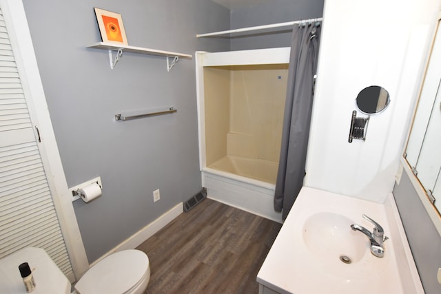 bathroom featuring toilet, wood finished floors, shower / bathtub combination with curtain, vanity, and baseboards