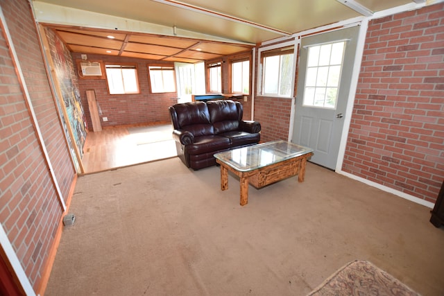 living area with brick wall and plenty of natural light