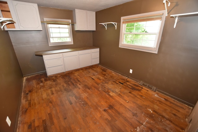 kitchen featuring white cabinets, dark wood finished floors, baseboards, open shelves, and a textured ceiling
