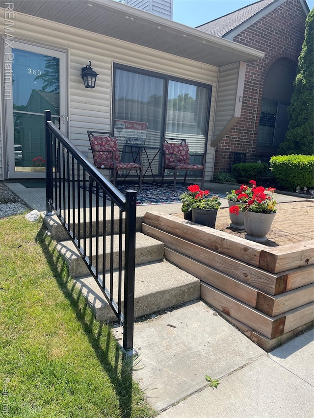 360 Spring Brooke Dr Unit 31, Brighton, MI 48116 - doorway to property featuring brick siding and a chimney