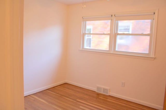 unfurnished room with wood finished floors and baseboards