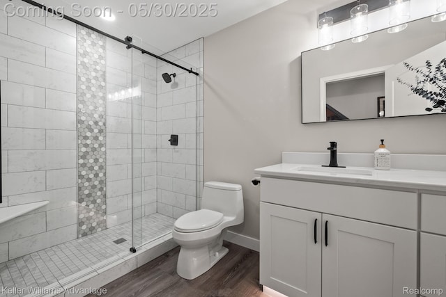 41740 Steinbeck Gln, Novi, MI 48377 - bathroom with toilet, wood finished floors, vanity, a stall shower, and baseboards