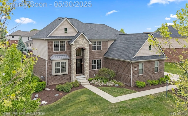 41740 Steinbeck Gln, Novi, MI 48377 - view of front facade with brick siding, a front lawn, and a shingled roof