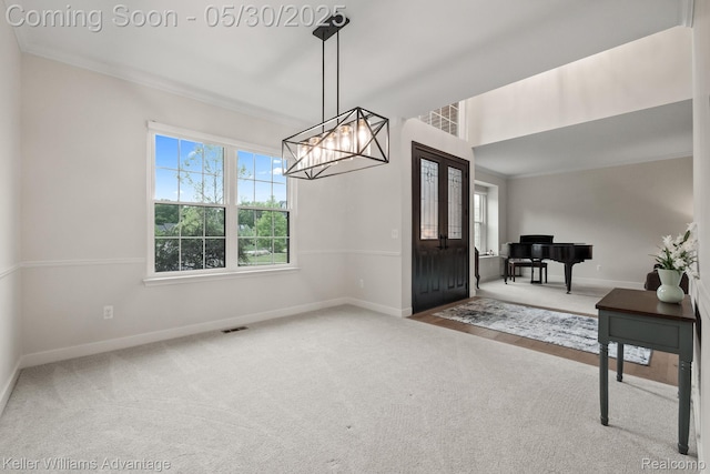 41740 Steinbeck Gln, Novi, MI 48377 - entrance foyer with baseboards, a chandelier, carpet flooring, and crown molding