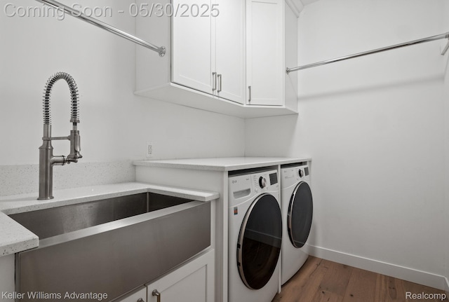 41740 Steinbeck Gln, Novi, MI 48377 - laundry room with washing machine and dryer, cabinet space, wood finished floors, and baseboards