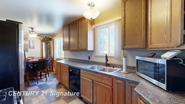 3455 Angel Dr, Saginaw, MI 48601 - kitchen with stainless steel appliances, a sink, plenty of natural light, and dark countertops