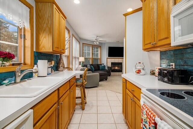 300 S Rath Ave Unit 1, Ludington, MI 49431 - kitchen with white appliances, a sink, ceiling fan, plenty of natural light, and recessed lighting
