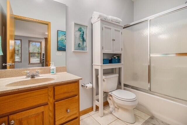 300 S Rath Ave Unit 1, Ludington, MI 49431 - full bath with toilet, vanity, combined bath / shower with glass door, and tile patterned flooring