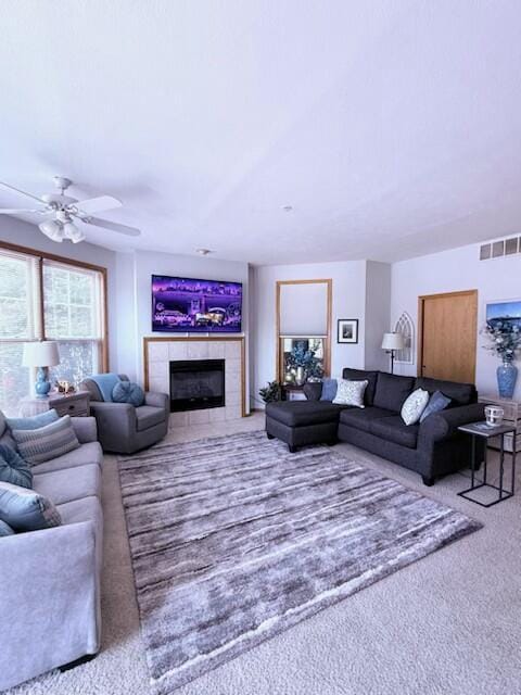 300 S Rath Ave Unit 1, Ludington, MI 49431 - living room with carpet, a tiled fireplace, and ceiling fan