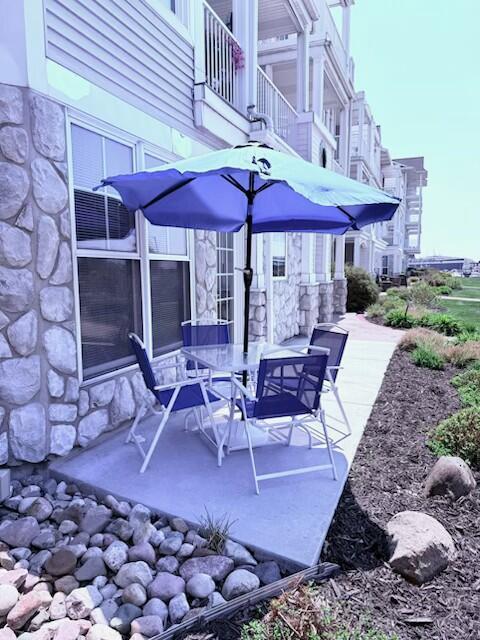 300 S Rath Ave Unit 1, Ludington, MI 49431 - view of patio / terrace with a balcony and outdoor dining area