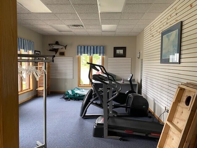300 S Rath Ave Unit 1, Ludington, MI 49431 - exercise area featuring a drop ceiling and baseboards