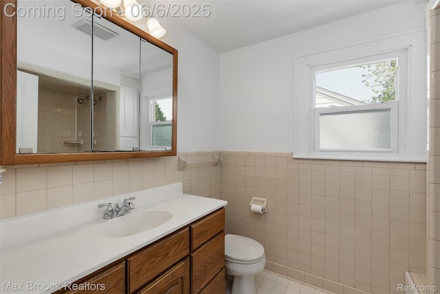 1215 Irving Ave, Royal Oak, MI 48067 - bathroom with tile walls, toilet, vanity, plenty of natural light, and wainscoting