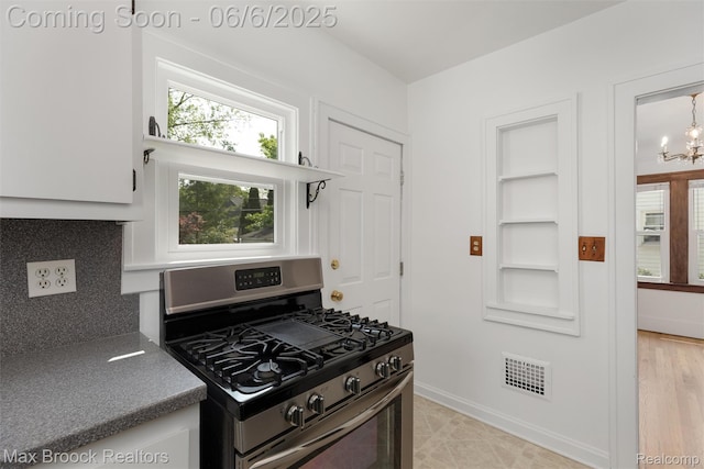 1215 Irving Ave, Royal Oak, MI 48067 - kitchen with stainless steel gas range, a chandelier, baseboards, and built in features
