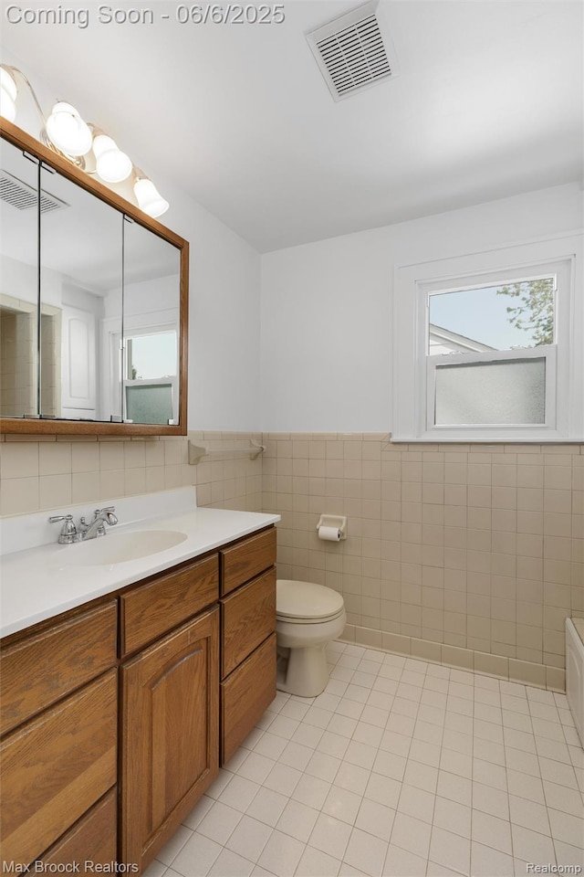 1215 Irving Ave, Royal Oak, MI 48067 - bathroom with tile walls, vanity, tile patterned flooring, toilet, and wainscoting
