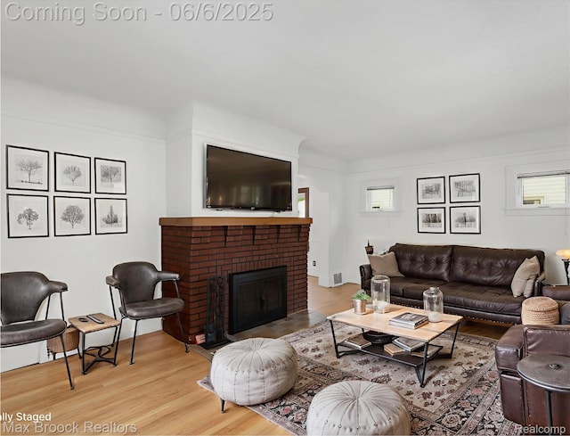 1215 Irving Ave, Royal Oak, MI 48067 - living room with light wood-style floors and a brick fireplace