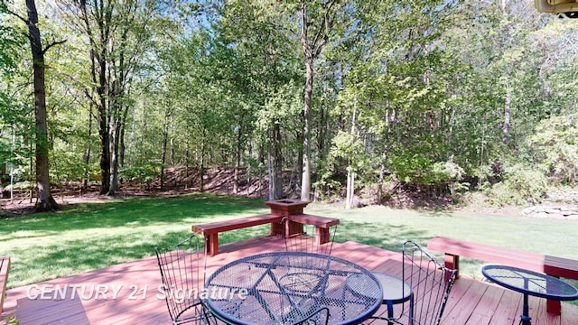 wooden terrace with a lawn and outdoor dining space