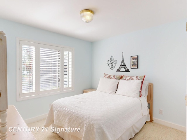 bedroom with carpet floors and baseboards