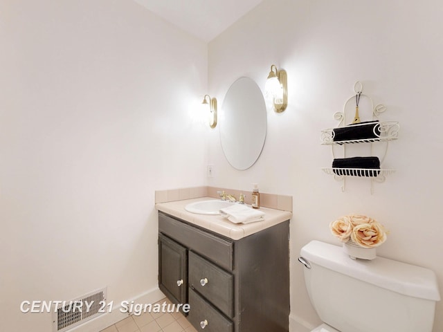 bathroom featuring toilet, vanity, and tile patterned floors
