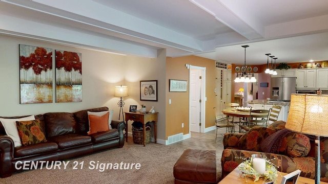 living room with beam ceiling, baseboards, and light colored carpet