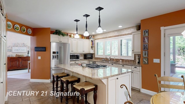 kitchen with stainless steel appliances, a sink, baseboards, healthy amount of natural light, and recessed lighting