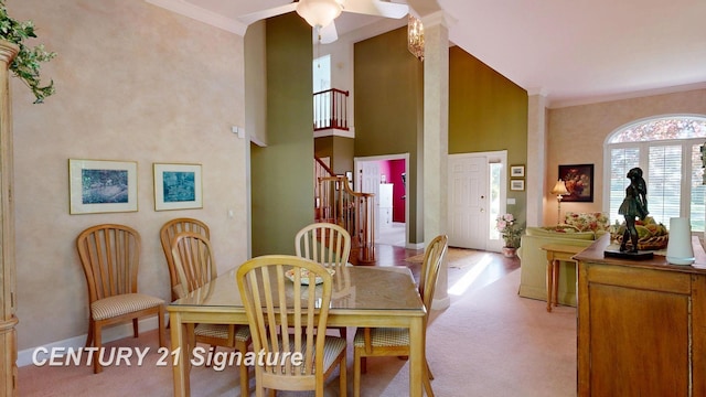 dining room with light carpet, stairs, crown molding, ceiling fan, and baseboards