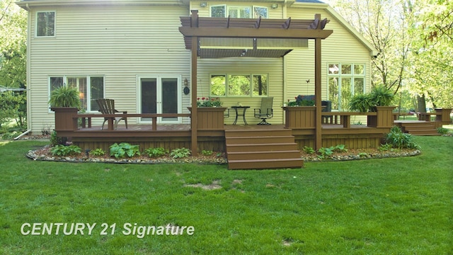rear view of house with a deck and a yard