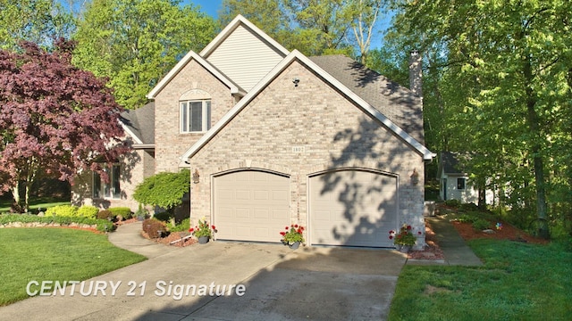 view of front facade with concrete driveway, a garage, a front yard, and a chimney