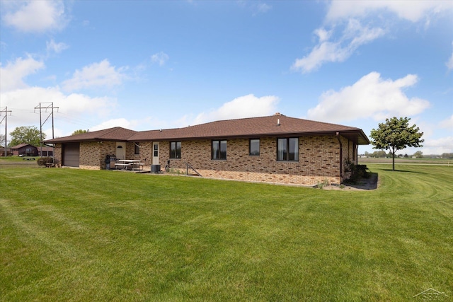 280 E Nebobish Rd, Essexville, MI 48732 - back of house with brick siding, a lawn, and central air condition unit