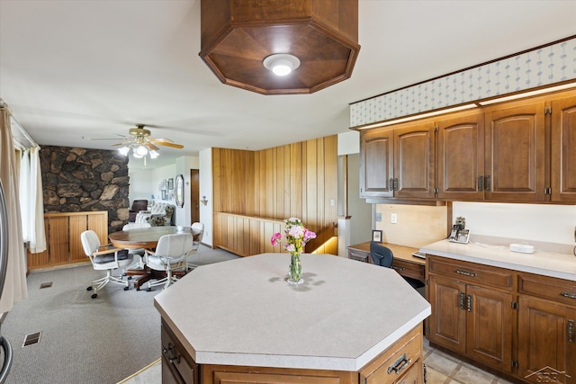 280 E Nebobish Rd, Essexville, MI 48732 - kitchen with a kitchen island, light countertops, a ceiling fan, open floor plan, and brown cabinets