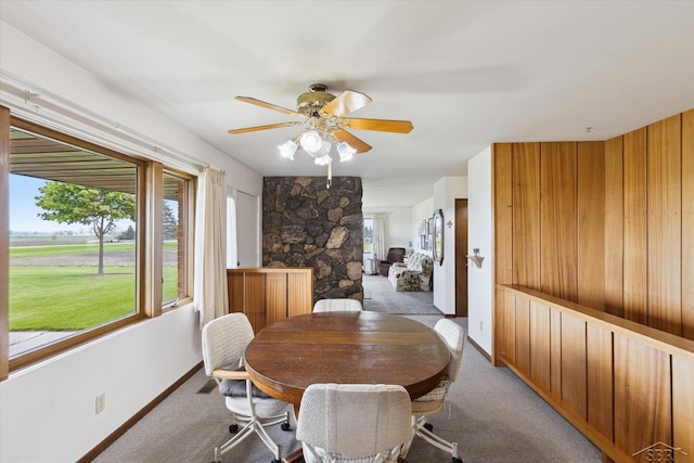 280 E Nebobish Rd, Essexville, MI 48732 - dining space with light carpet, baseboards, and a ceiling fan