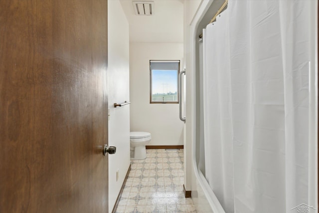 280 E Nebobish Rd, Essexville, MI 48732 - bathroom with tile patterned floors, toilet, baseboards, and a shower with shower curtain